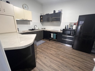 Renovated kitchen with gas cooktop, underbench oven, microwave and full-size family fridge - 3 Bedroom Cottage, Longhorn Ranch Apartments Orbost