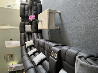 Main lounge with large leather modular recliner lounges in the 5 bedroom apartment - 5 Bedroom Apartment, Longhorn Ranch Apartments Orbost