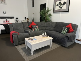 Studio living area with large corner recliner lounge and coffee table - Studio Apartment, Longhorn Ranch Apartments Orbost