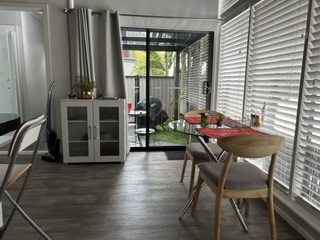Dining table for two beside the sliding door out to the private courtyard - Studio Apartment, Longhorn Ranch Apartments Orbost