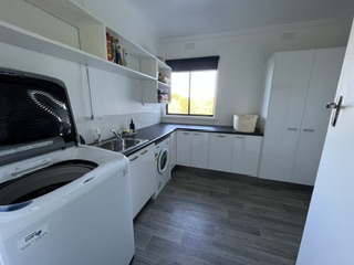 New laundry with washer, dryer, twin sinks and full-height storage - 5 Bedroom Apartment, Longhorn Ranch Apartments Orbost